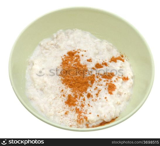 traditional english oat porridge with cinnamon in yellow bowl isolated on white background