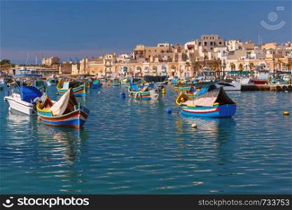 Traditional eyed colorful boats Luzzu in the Harbor of Mediterranean fishing village Marsaxlokk, Malta. Taditional eyed boats Luzzu in Marsaxlokk, Malta