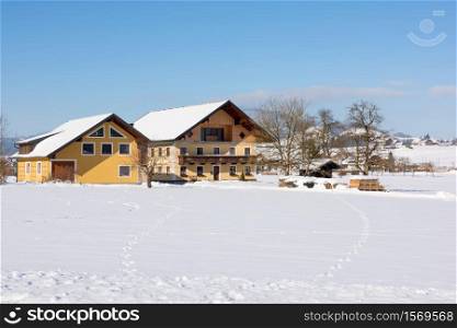 Traditional farmhouse and barns in farmland near Salzburg, in Austria