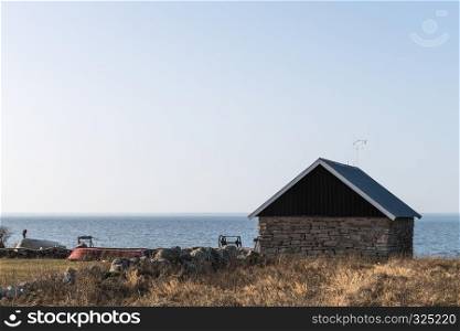 Traditional fishing site with cabin built of limestone at the swedish island Oland in the Baltic Sea