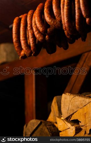 Traditional food. Smoked sausages meat hanging in domestic smokehouse.
