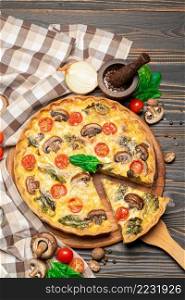 Traditional french Baked homemade quiche pie on wooden cutting board. Traditional french Baked homemade quiche pie on wooden board