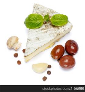 traditional french brie cheese, olives and mushroom isolated on a white background. traditional french brie cheese, olives and mushroom on a white background