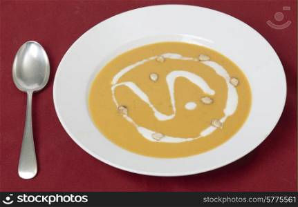 Traditional French butternut squash cream soup with soured cream and toaste squash seed garnish.