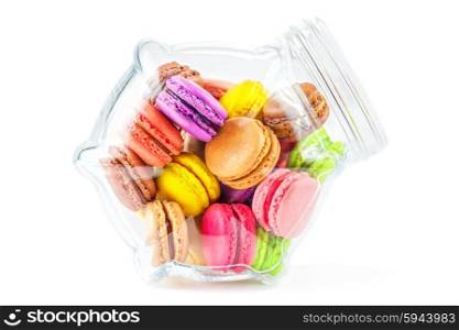 traditional french colorful macarons in a glass jar on white background. french colorful macarons in a glass jar