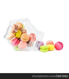 traditional french colorful macarons in a glass jar on white background