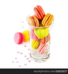 traditional french colorful macarons in a glass on white background
