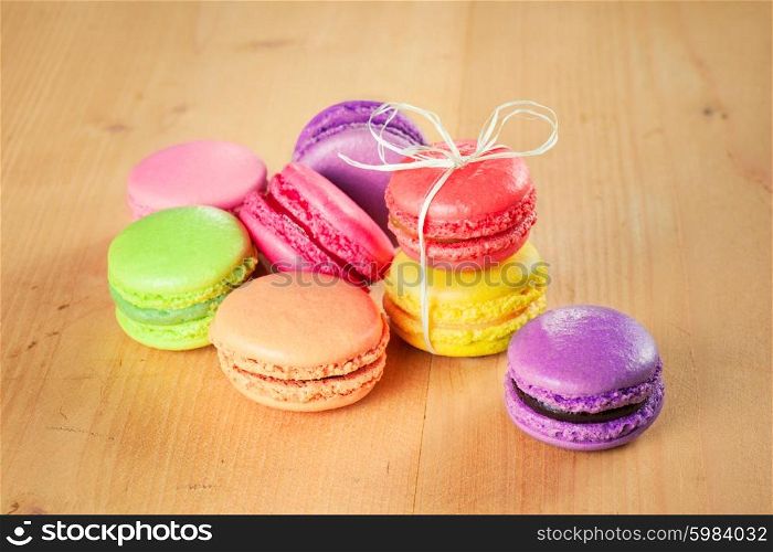 traditional french colorful macarons on wooden table