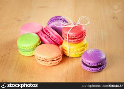 traditional french colorful macarons on wooden table