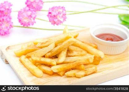 Traditional French fries . Traditional French fries on wooden plate with tomato sauce