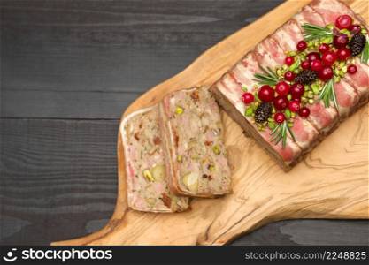 Traditional French terrine covered with bacon and Christmas decoration on dark wooden background. High quality photo. Traditional French terrine covered with bacon on dark wooden background