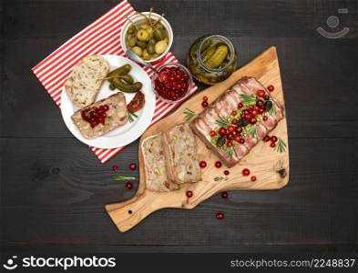 Traditional French terrine covered with bacon and Christmas decoration on dark wooden background. High quality photo. Traditional French terrine covered with bacon on dark wooden background