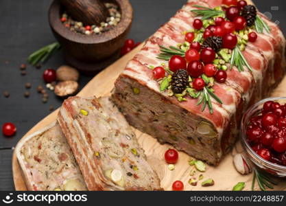 Traditional French terrine covered with bacon and Christmas decoration on dark wooden background. High quality photo. Traditional French terrine covered with bacon on dark wooden background