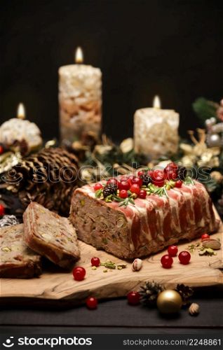 Traditional French terrine covered with bacon and Christmas decoration on dark wooden background. High quality photo. Traditional French terrine covered with bacon and Christmas decoration on dark wooden background