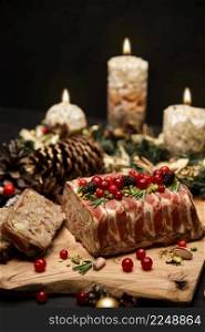 Traditional French terrine covered with bacon and Christmas decoration on dark wooden background. High quality photo. Traditional French terrine covered with bacon and Christmas decoration on dark wooden background