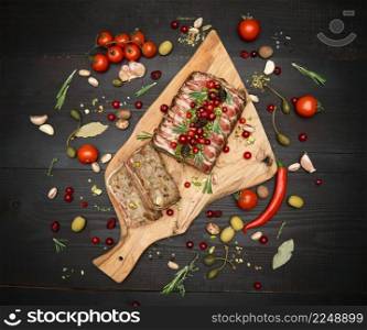 Traditional French terrine covered with bacon on dark wooden background. High quality photo. Traditional French terrine covered with bacon on dark wooden background