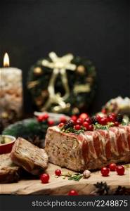 Traditional French terrine covered with bacon on dark wooden background with Christmas decorations. High quality photo. Traditional French terrine covered with bacon on dark wooden background with Christmas decorations