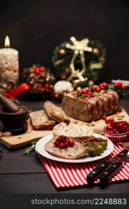 Traditional French terrine covered with bacon on dark wooden background with Christmas decorations. High quality photo. Traditional French terrine covered with bacon on dark wooden background with Christmas decorations