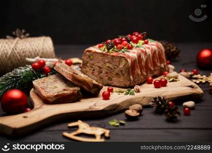 Traditional French terrine covered with bacon on dark wooden background with Christmas decorations. High quality photo. Traditional French terrine covered with bacon on dark wooden background with Christmas decorations