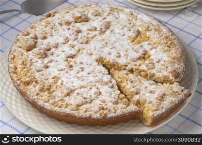 Traditional fresh baked Dutch Apple crumble cake and a piece close up