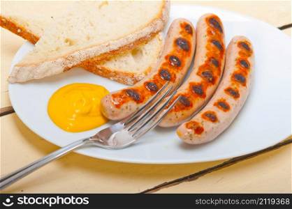 traditional fresh German wurstel sausages grilled with yellow mustard