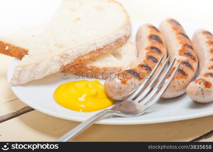 traditional fresh German wurstel sausages grilled with yellow mustard