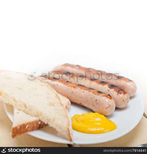 traditional fresh German wurstel sausages grilled with yellow mustard