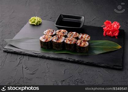Traditional fresh japanese sushi futomaki on black stone