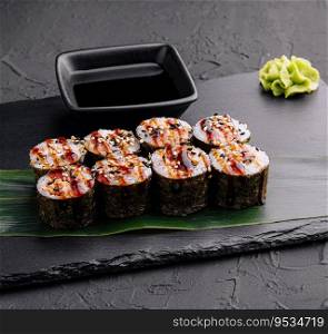 Traditional fresh japanese sushi futomaki on black stone