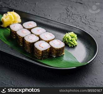 Traditional fresh japanese sushi maki on black stone plate