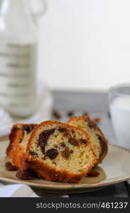 Traditional fruit cake with dried fruits are on the wooden table.