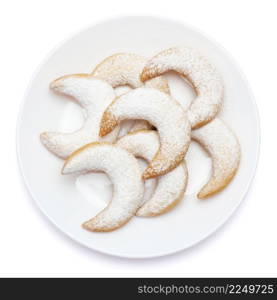 Traditional German or Austrian Vanillekipferl vanilla kipferl cookies on a plate isolated on white background. High quality photo. Traditional German or Austrian Vanillekipferl vanilla kipferl cookies on a plate isolated on white background