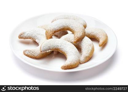 Traditional German or Austrian Vanillekipferl vanilla kipferl cookies on a plate isolated on white background. High quality photo. Traditional German or Austrian Vanillekipferl vanilla kipferl cookies on a plate isolated on white background