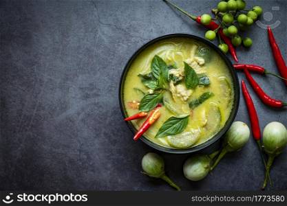 Traditional green curry chicken cuisine asian food, Chicken green curry Thai food on soup bowl with ingredient vegetable herbs and spices pepper chili. Top view