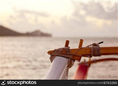 Traditional hawaii canoe on beach in Waikiki with Diamond Head in distance