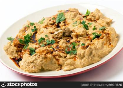 Traditional homemade Ottoman circassian chicken, shredded meat in walnut sauce, drizzled with walnut oil coloured with paprika