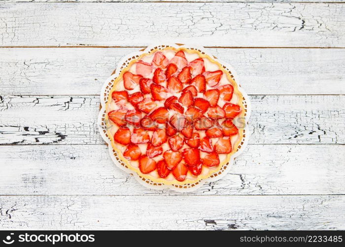 Traditional homemade strawberry cake on wooden background. Homemade Strawberry cake