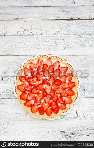 Traditional homemade strawberry cake on wooden background. Homemade Strawberry cake