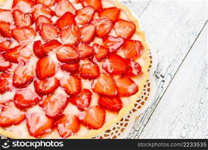 Traditional homemade strawberry cake on wooden background. Homemade Strawberry cake