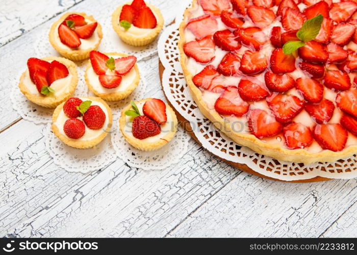 Traditional homemade strawberry cake on wooden background. Homemade Strawberry cake