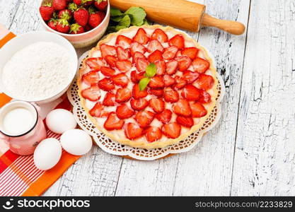 Traditional homemade strawberry cake on wooden background. Homemade Strawberry cake