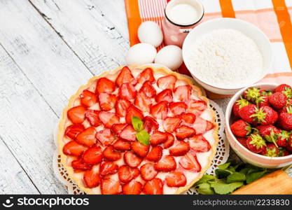 Traditional homemade strawberry cake on wooden background. Homemade Strawberry cake