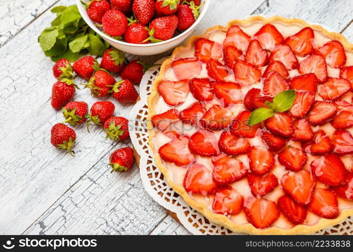 Traditional homemade strawberry cake on wooden background. Homemade Strawberry cake