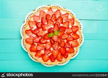 Traditional homemade strawberry cake on wooden background. Homemade Strawberry cake