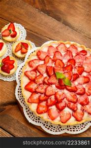 Traditional homemade strawberry cake on wooden background. Homemade Strawberry cake