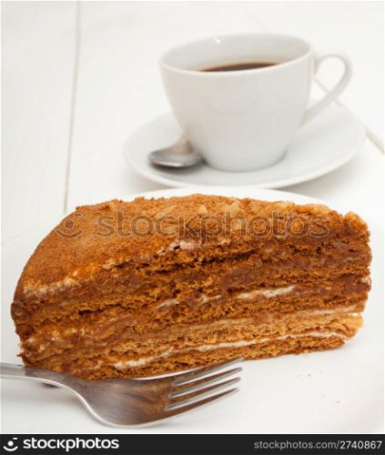 Traditional Honey Cake on Plate and White Cup of Coffee on Table
