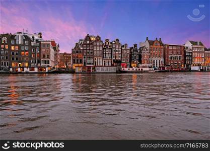 Traditional houses along the river Amstel in Amsterdam the Netherlands at sunset