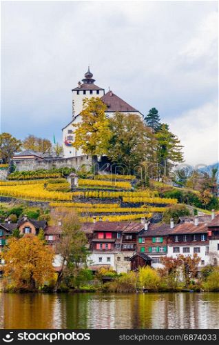 Traditional houses, church. Switzerland. Beautiful Alpine landscape with church and typical Swiss houses at autumn day