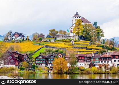 Traditional houses, church. Switzerland. Beautiful Alpine landscape with church and typical Swiss houses at autumn day
