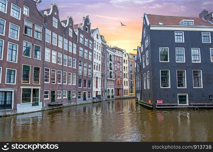 Traditional houses in Amsterdam in the Netherlands at sunset